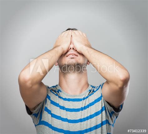 Young Caucasian Man Hiding His Face With Hand Stock Photo And Royalty