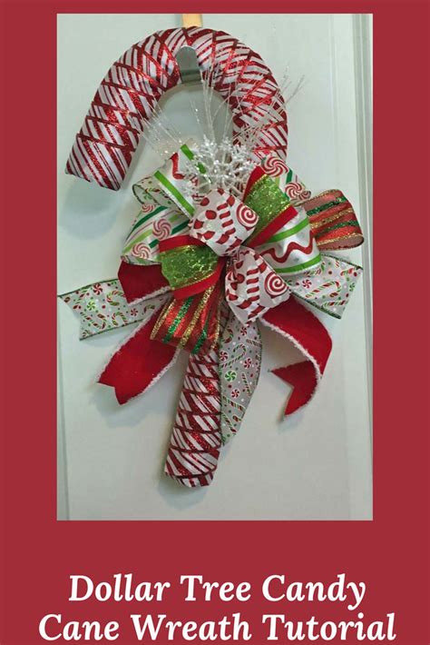 A Christmas Wreath With Candy Canes And Bows Hanging On The Front Door