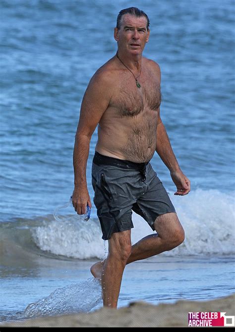shirtless pierce brosnan looked handsome as he emerged from the sea while on holiday in hawaii