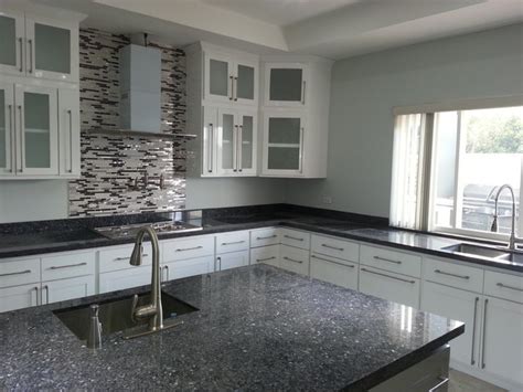 Light blue kitchen cabinets with white countertops. White Harmony Kitchen with Blue Pearl Granite Top ...