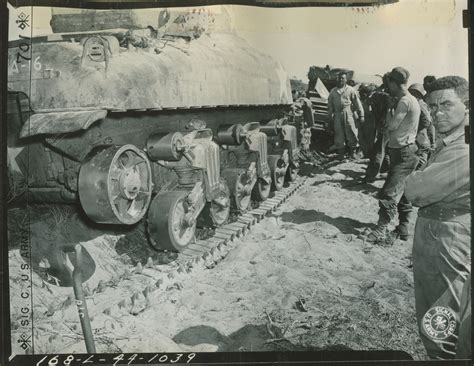 Tank Crew Members Repairing A Damaged M4 Sherman Tank In The Field