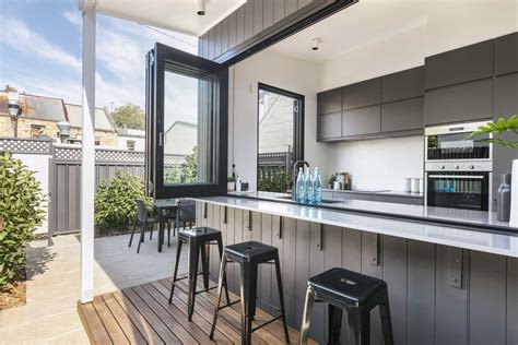 A Wall Of Bi Fold Windows Open This Kitchen To The Outdoors