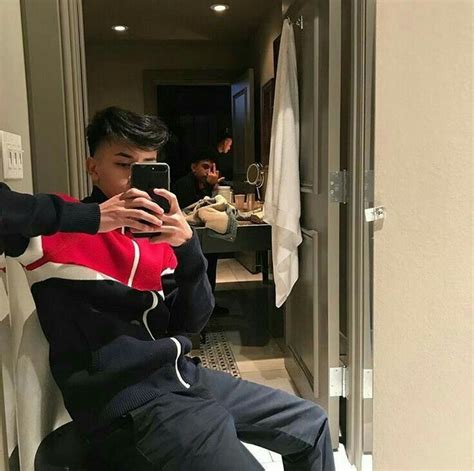 A Man Taking A Selfie In The Bathroom While Sitting On A Toilet With His Cell Phone