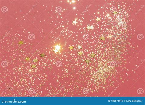 Gold Glitter And Star Confetti On A Red Background Stock Photo Image