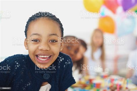 Black Girl Enjoying A Birthday Party With Friends At The Back Stock