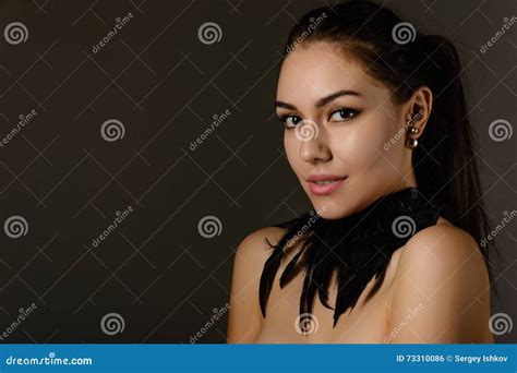 Portrait Of Beautiful Brunette With Hair Gathered In A Ponytail Stock