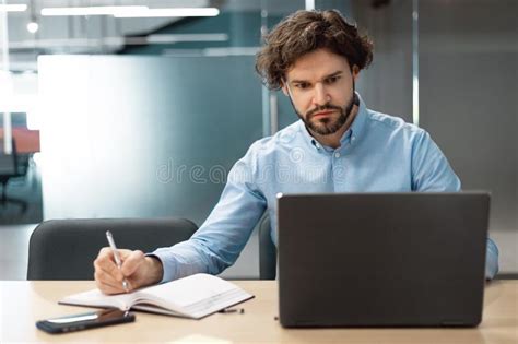 Portrait Of Focused Man Using Laptop And Writing Stock Image Image Of