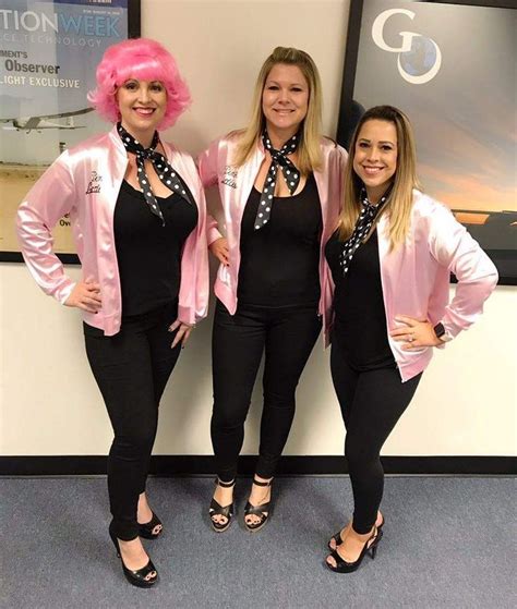 Three Women Dressed In Black And Pink Posing For The Camera