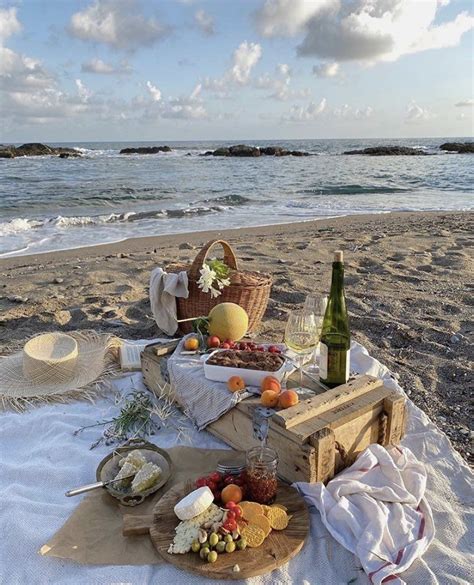 A Picnic On The Beach With Food And Wine