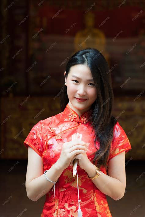 Premium Photo Portrait Of Chinese Girl Wearing Chinese Clothes Posing At Cement Door