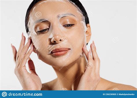 beautiful woman in a moisturizing facial mask skin care woman applying a cosmetic tissue mask