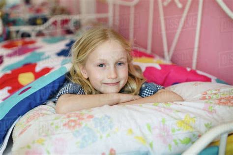 Portrait Of Girl Lying On Bed Stock Photo Dissolve