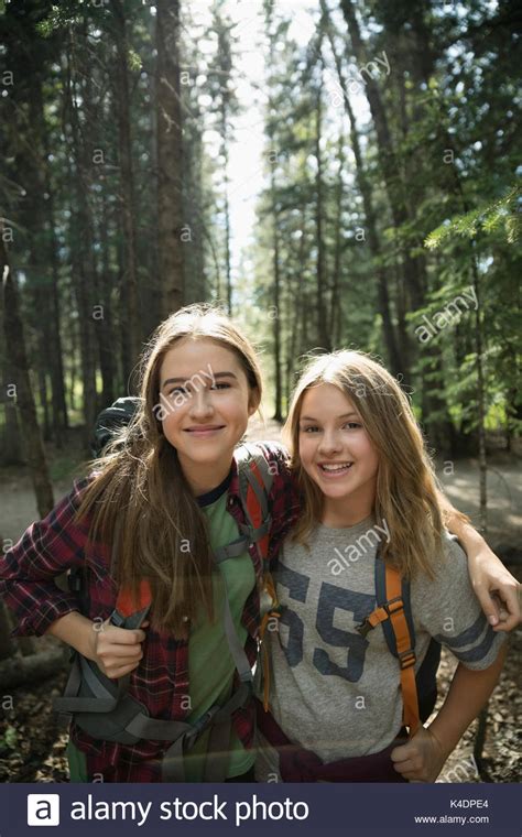 Portrait Confident Smiling Teenage Girl Friends Hiking In Woods Stock