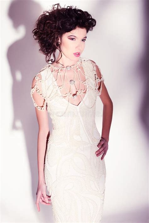 Beautiful Woman Model Posing In Elegant Pearl Dress In The Studio Stock