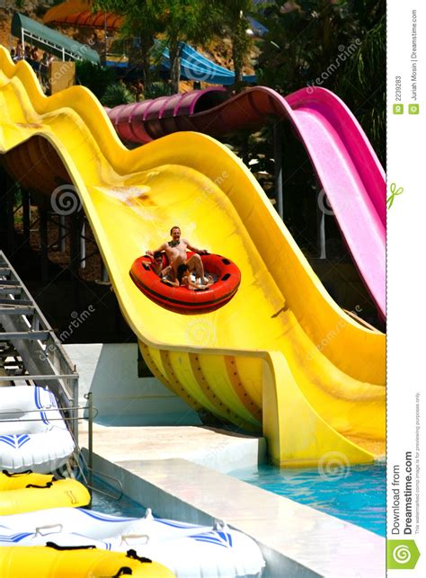 Of all places, he climbs up a step he kicks his feet and slides out from underneath revealing this priceless photo. Sliding Down The Big Slide. Stock Image - Image of blue ...