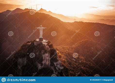 Christ The Redeemer Statue On Top Of Corcovado Mountain At Sunset Rio