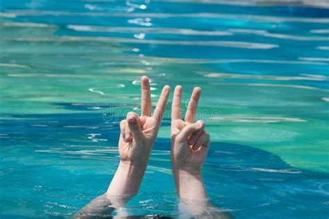 Two Hands Out Of Water In Rock Gesture Stock Image Image Of Rescue