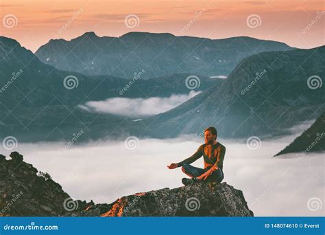 Yoga Meditation In Mountains Man Traveler Relaxing Alone Stock Photo