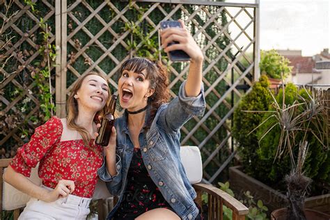 Two Girls Taking A Selfie Outdoors By Stocksy Contributor Luis