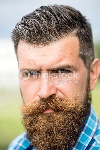 Portrait Of Attractive Sullen Unshaven Man With Long Beard And