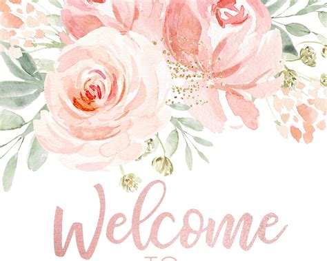 A Welcome Sign With Pink Flowers And Greenery