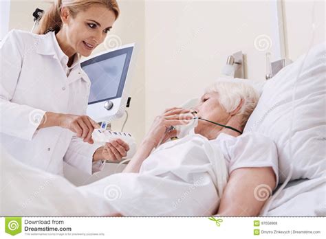 Brilliant Sweet Doctor Giving Her Patient New Instructions Stock Image