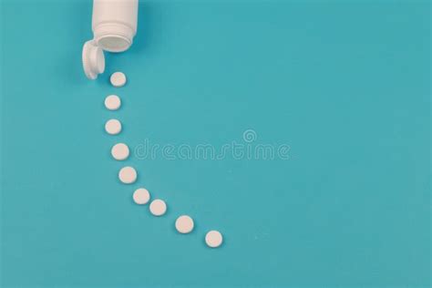 pills spilled out of white bottle on blue background stock image image of medication health