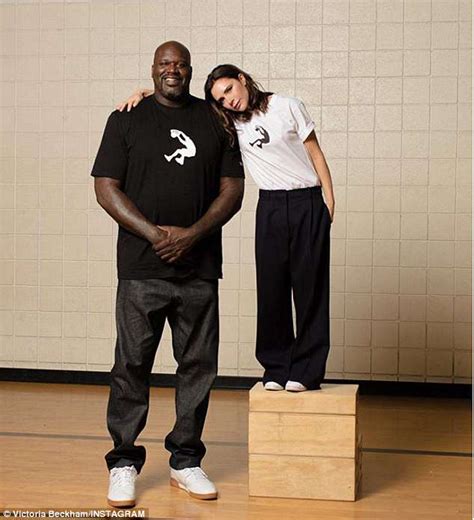 Superman, shaq, diesel, the big aristotle. Victoria Beckham poses besides Shaquille O'Neal to promote ...