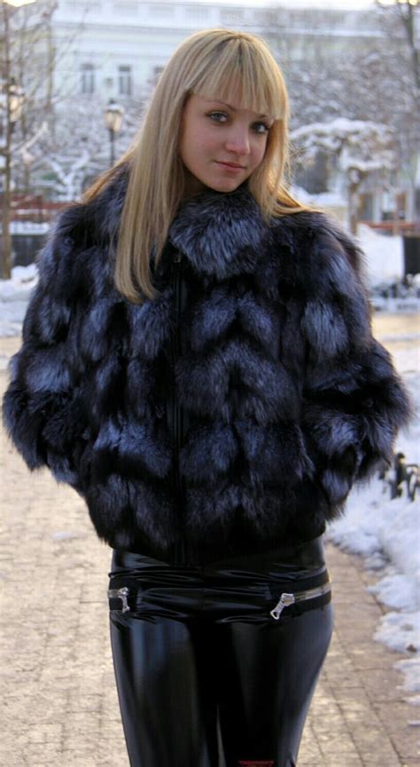 A Woman In Black Leather Pants And A Fur Coat