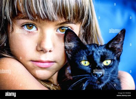 Portrait Of A Beautiful Little Girl Holding A Black Cat Stock Photo Alamy