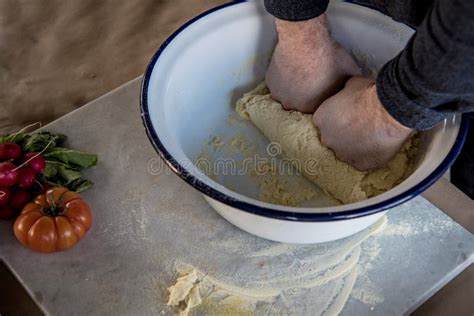 Hands Of Man Kneading Yeast Dough On Floured Kitchen Counter Stock