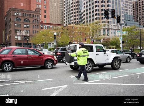 boston police officer directing traffic downtown at busy congress street and atlantic avenue