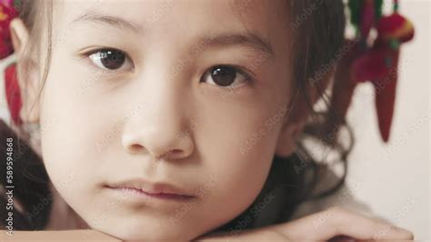 video stock close up 4k with slow motion of 6 years old asian girl who is waiting with sad and