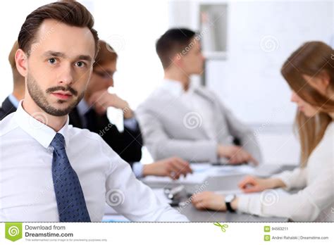 Portrait Of Business Man Against A Group Of Business People At A