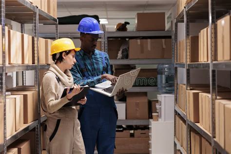 Warehouse Supervisors Discussing Goods Inventory Checking Report On