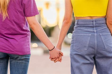 Premium Photo Unrecognizable Lesbian Couple Holding Hands Young Dating Together In A Female
