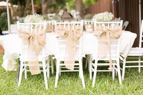 During the reception, all guests require a chair for dinner and dessert. White Chiavari Reception Chairs with Burlap Sashes