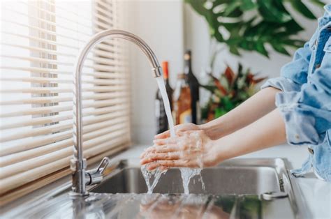 Premium Photo Woman Washing Hands In Sink Before Cooking In Kitchen