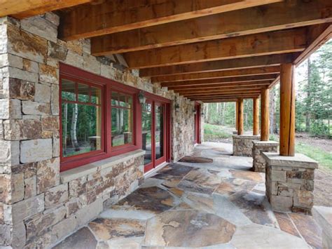 Denver egress window of denver, colorado specializes in walk out basement renovations. Stone façade, patio, and post foundations; daylighting for ...