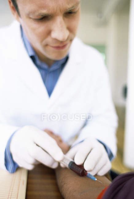 Doctor Taking Blood Sample From Patient Arm — Male Haematology