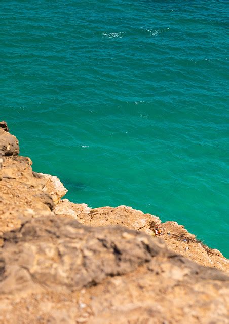 Cliff Over The Green Water Dhofar Governorate Taqah Oman A Photo