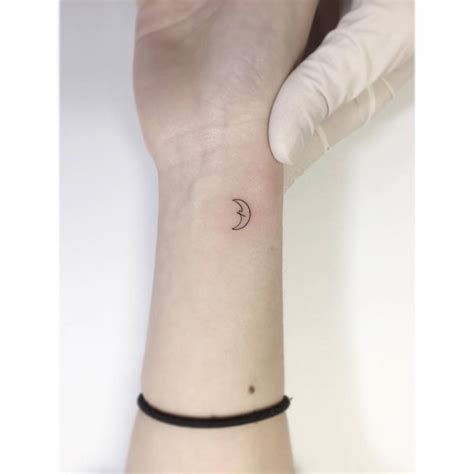 Fine Line Crescent Moon Tattoo Placed On The Wrist