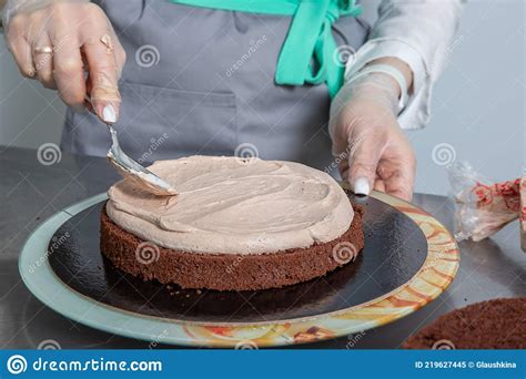 Woman Hands Chef Spreading Cream On First Layer Of Chocolate Cake Stock Image Image Of