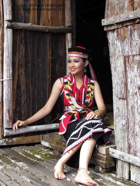 A Traditional Bidayuh Costume At A Doorstep Of A Traditional Bidayuh Longhouse At Sarawak