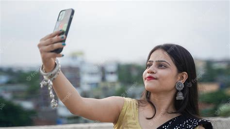 Premium Photo Beautiful Indian Girl Taking Selfie On Her Mobile Phone Outdoor Cheerful Asian