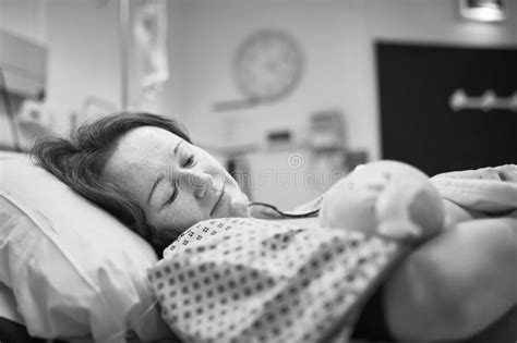 Mother Holding Her Newborn Baby Right After Delivery Stock Photo