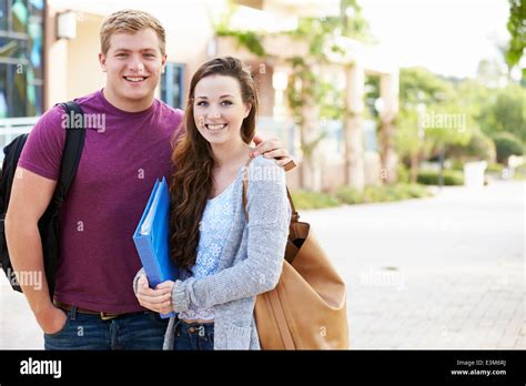 Portrait Of Student Couple Outdoors On University Campus Stock Photo