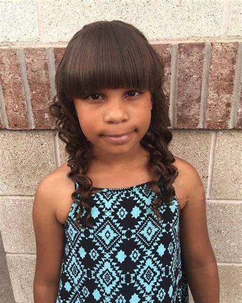 A thin braid instead of a headband is a simple and lovely idea of how you can style little girls haircuts. 15 Best Hairstyles for 10 Year Old Black Girls - Child Insider