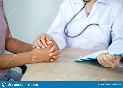 Doctor Holding Hands To Encouragement And Explained The Health