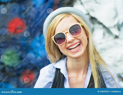 Portrait Of Smiling Hipster Girl Wearing Sunglasses Outdoors Stock